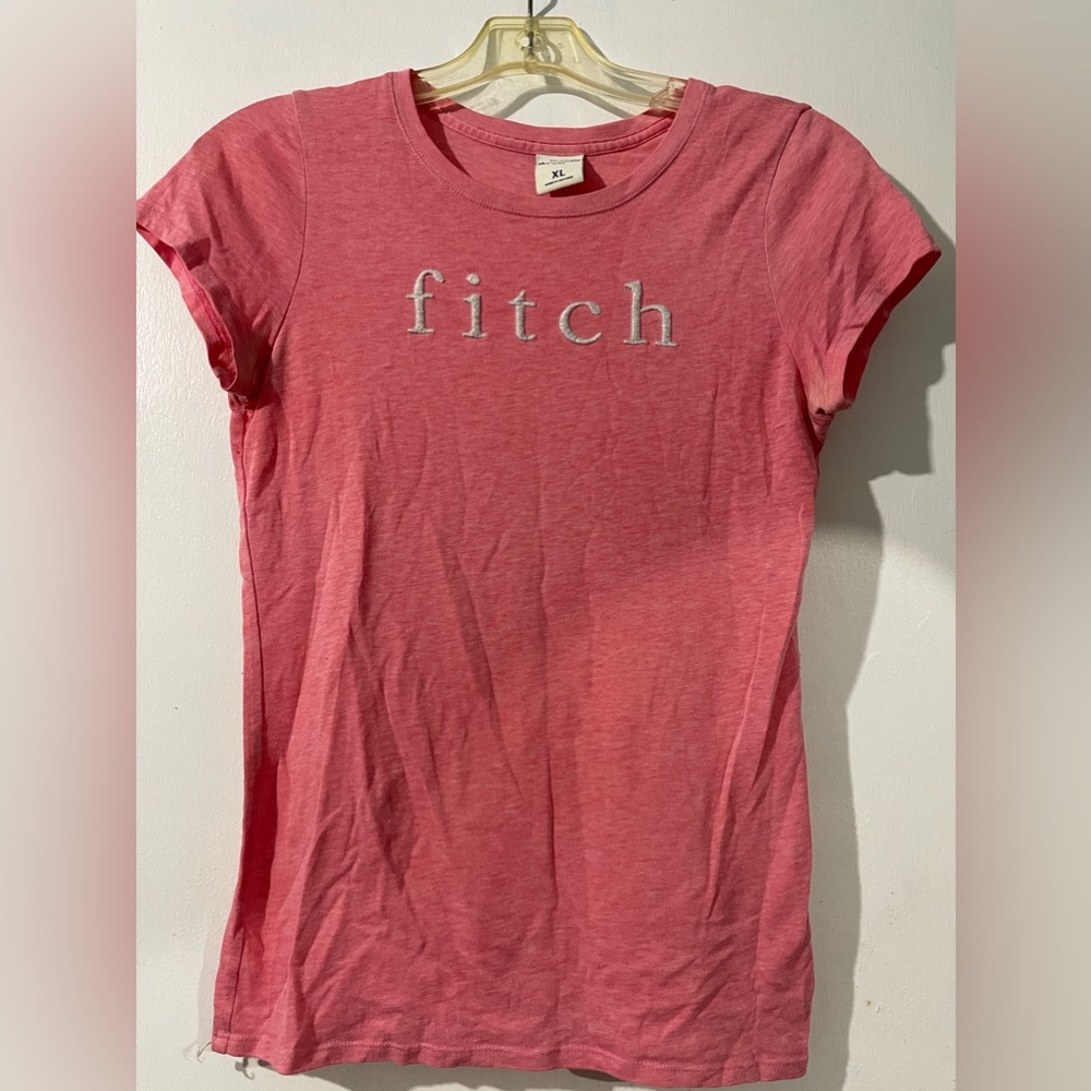 Light pink shirt.